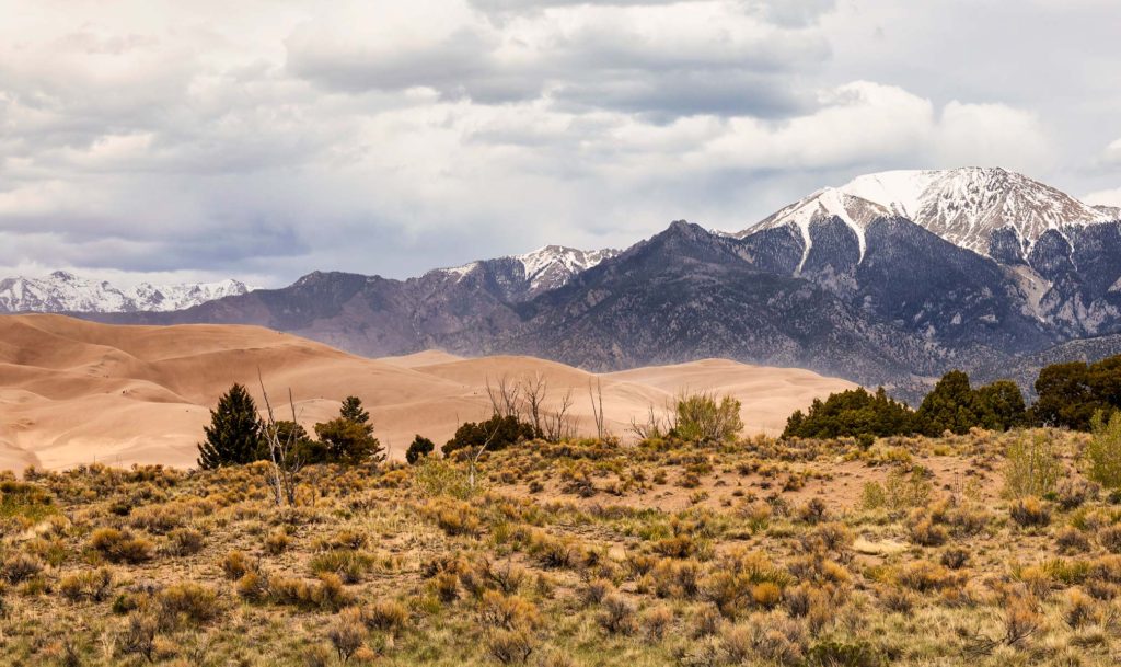 great sand dunes national Park with snow capped mountain