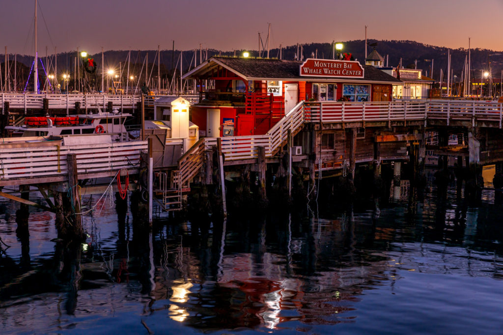 Monterey wharf at dusk with light reflections