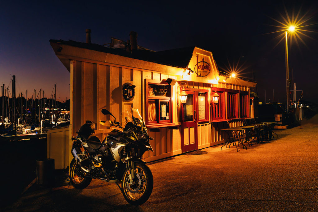 night photo of motorcycle on Monterey fishing wharf