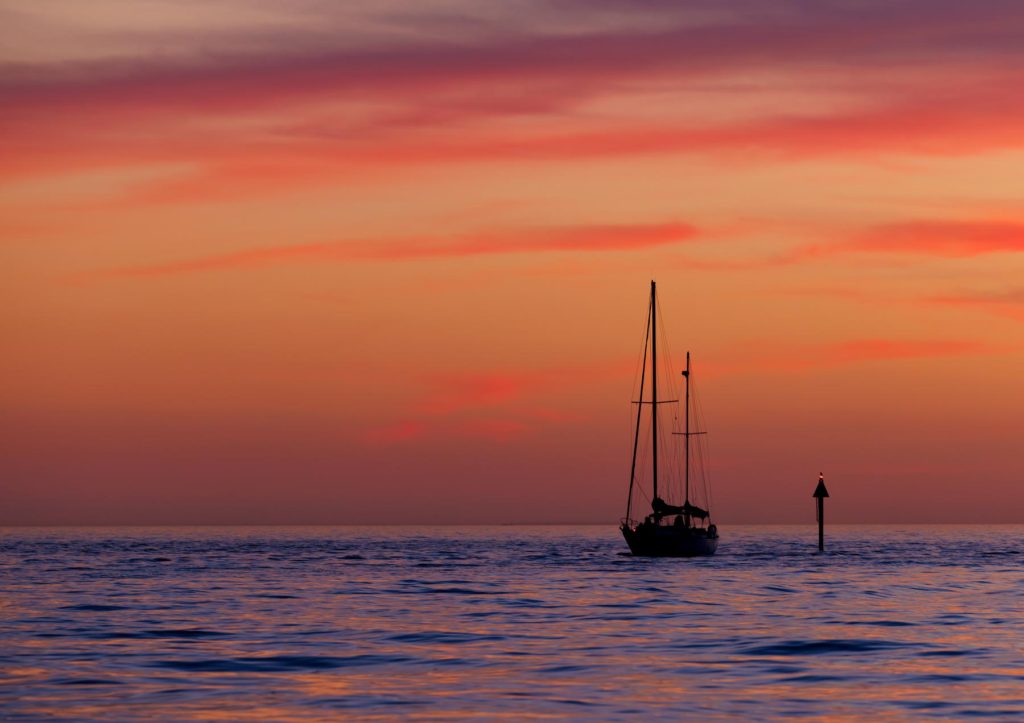 sailboat coming home in sunset