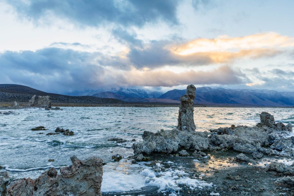 Tufa formations against the mountains and sunset sky at Mono Lake, California