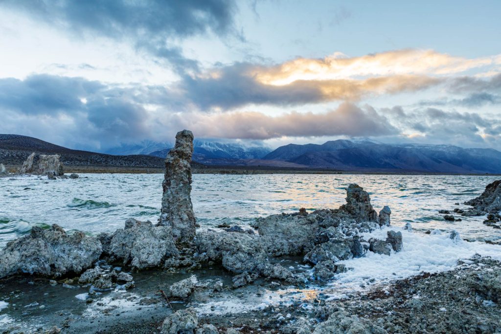 Tufa formations at Mono Lake in California with mountains and clouds