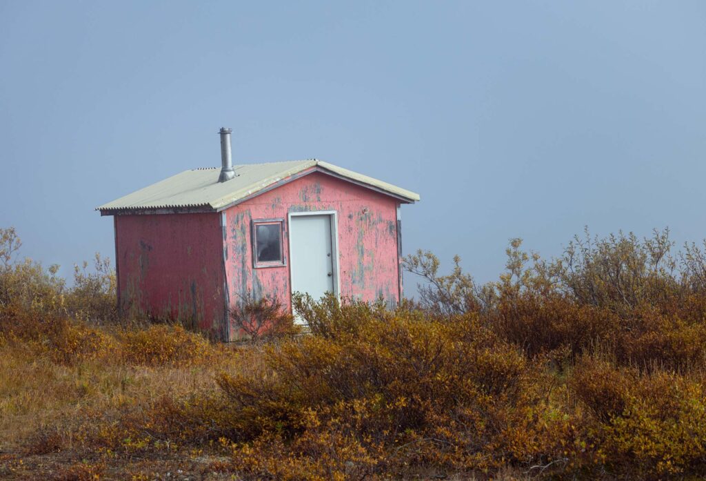 A small camp hut most likely used while hunting in remote western Alaska near Nome and Teller